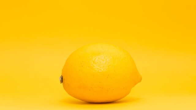 yellow lemon fruit on white surface