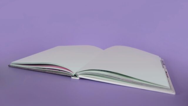 opened book on purple surface